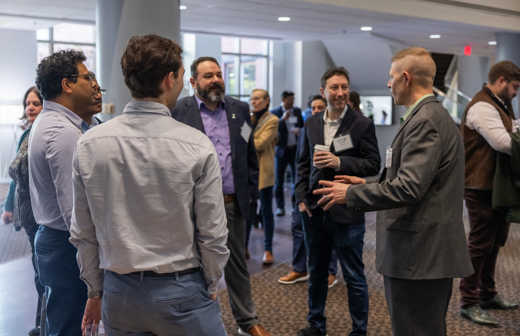 A group of five networking and talking.